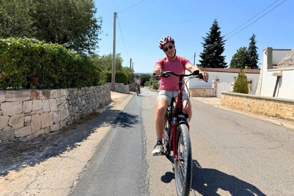 Rolling countryside of Puglia with dry stone walls and olive groves seen from a bike trail