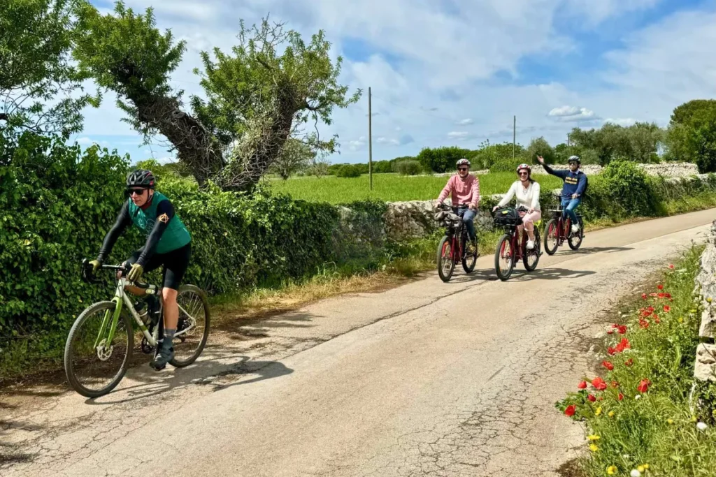 Cyclists approaching the Murgia Timone belvedere overlooking Matera canyon