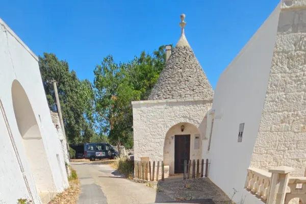 Narrow alley in Locorotondo with whitewashed houses and flowered balconies