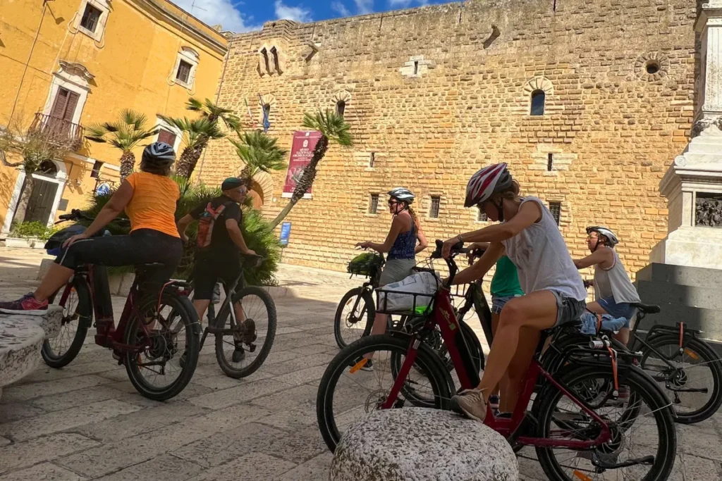 Happy cyclists raising glasses after completing a wine bike tour