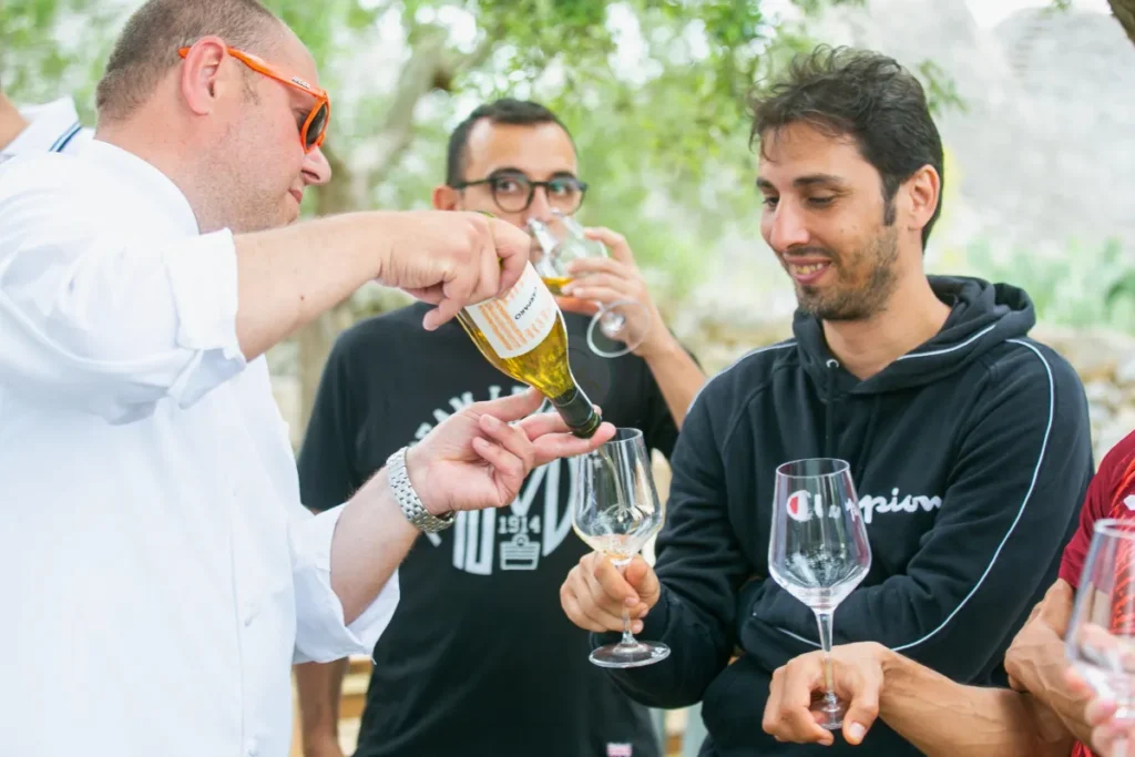 Guests enjoying a wine tasting in a local masseria courtyard