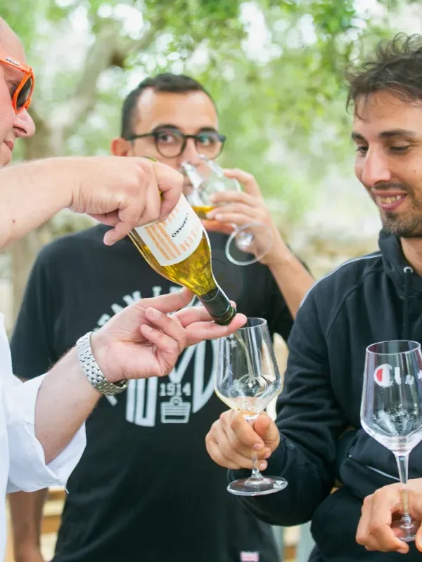 Guests enjoying a wine tasting in a local masseria courtyard