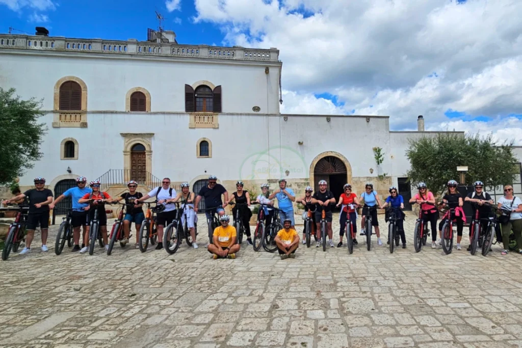 Group of colleagues participating in an e-bike team building experience in the Murgia landscape